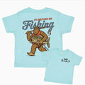 Light blue t-shirt with a graphic of BigFoot holding a fish and text 'I'd Rather Be Fishing' 